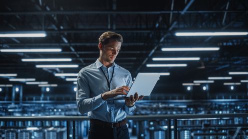 Portrait,Of,It,Specialist,Uses,Laptop,In,Data,Center.,Server